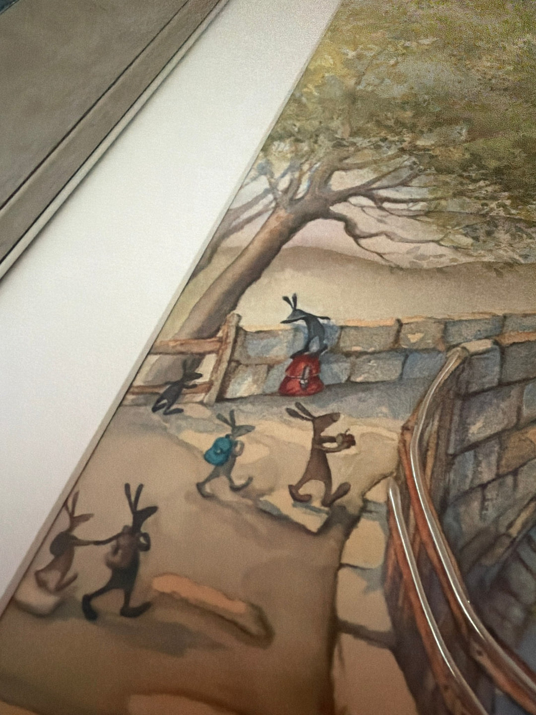 Carrot Cottage School by Catherine Stephenson – close-up of the hares walking to school by the silver bridge rail