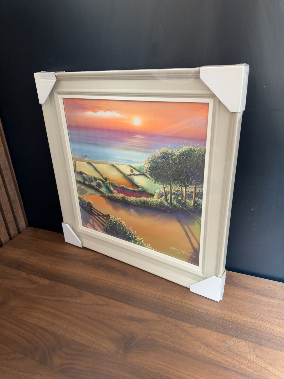 Coastal Sunset trial artwork by Catherine Stevenson in a cream frame