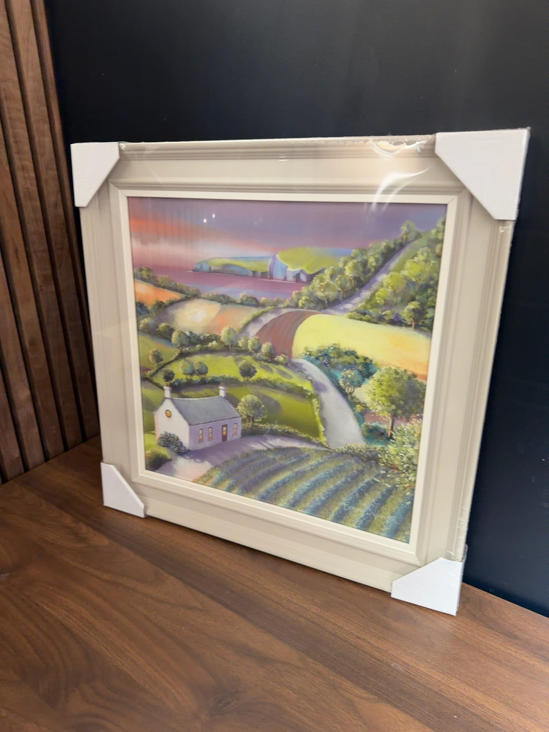 Country Cottage trial artwork by Catherine Stevenson in a cream frame